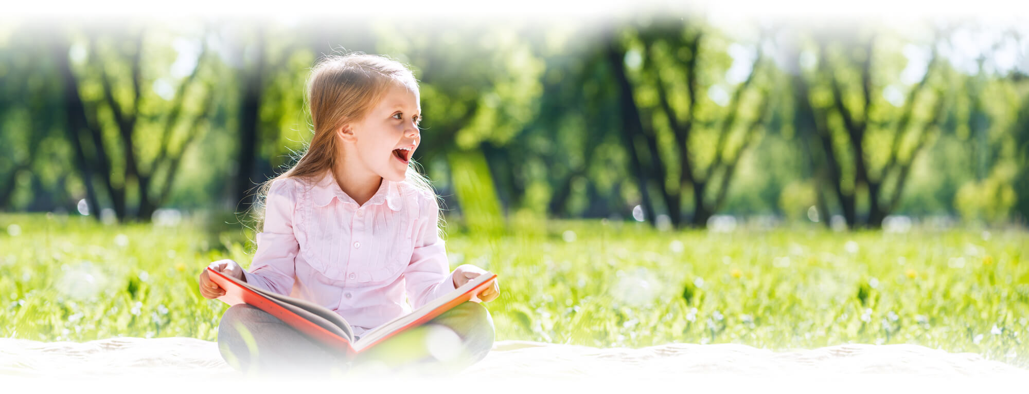 excited young girl holding book
