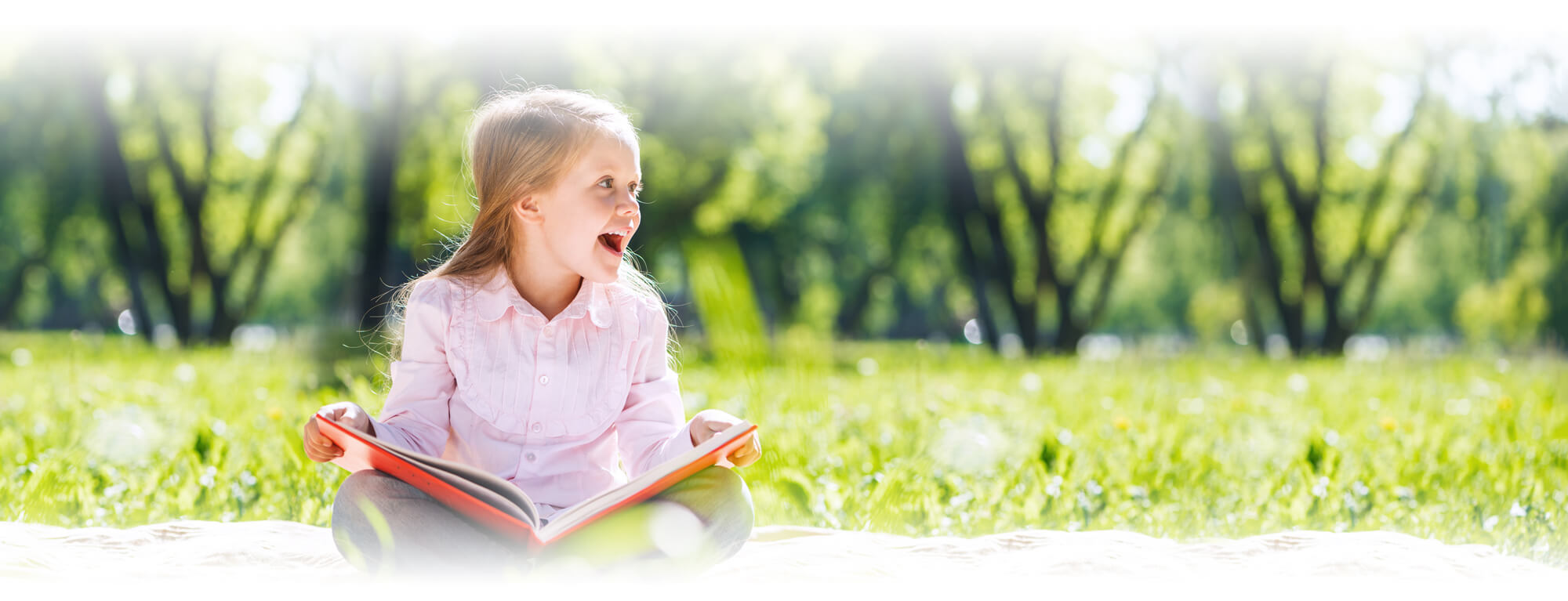 happy first grade girl reading a book