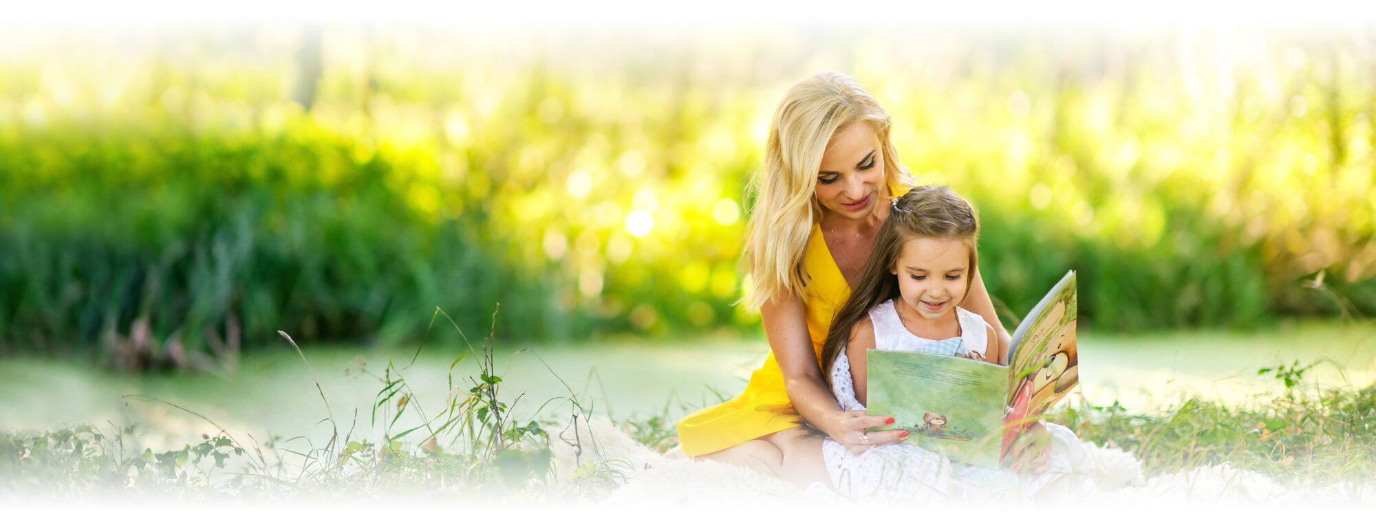 mother and preschool girl reading book