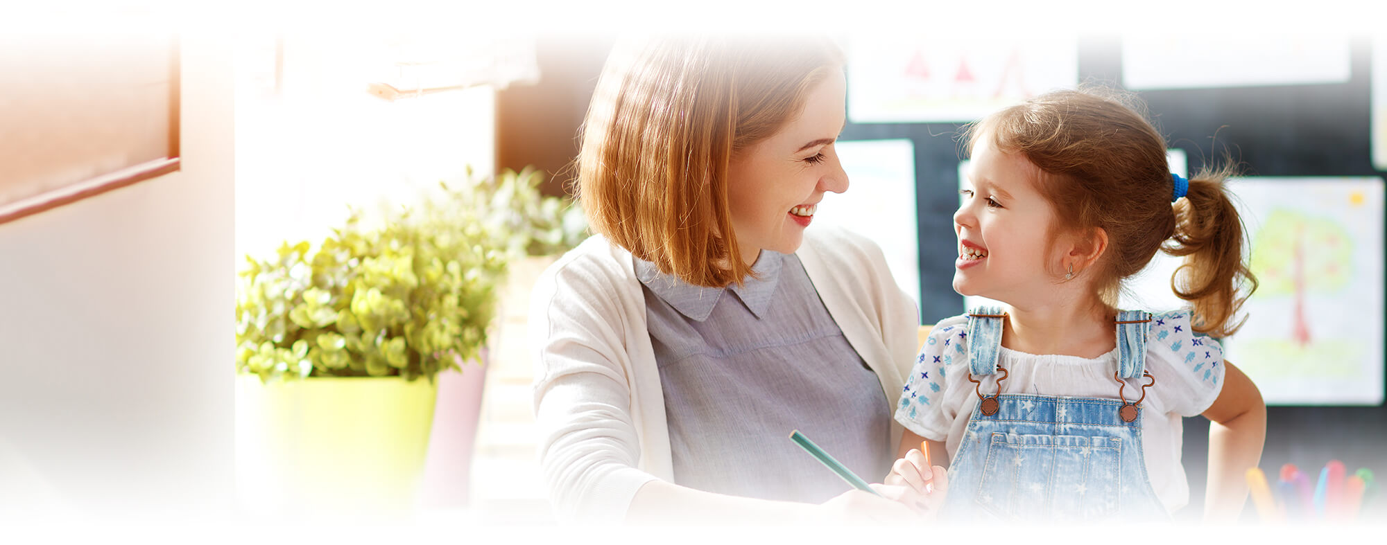 Happy mother with smiling kindergarten girl